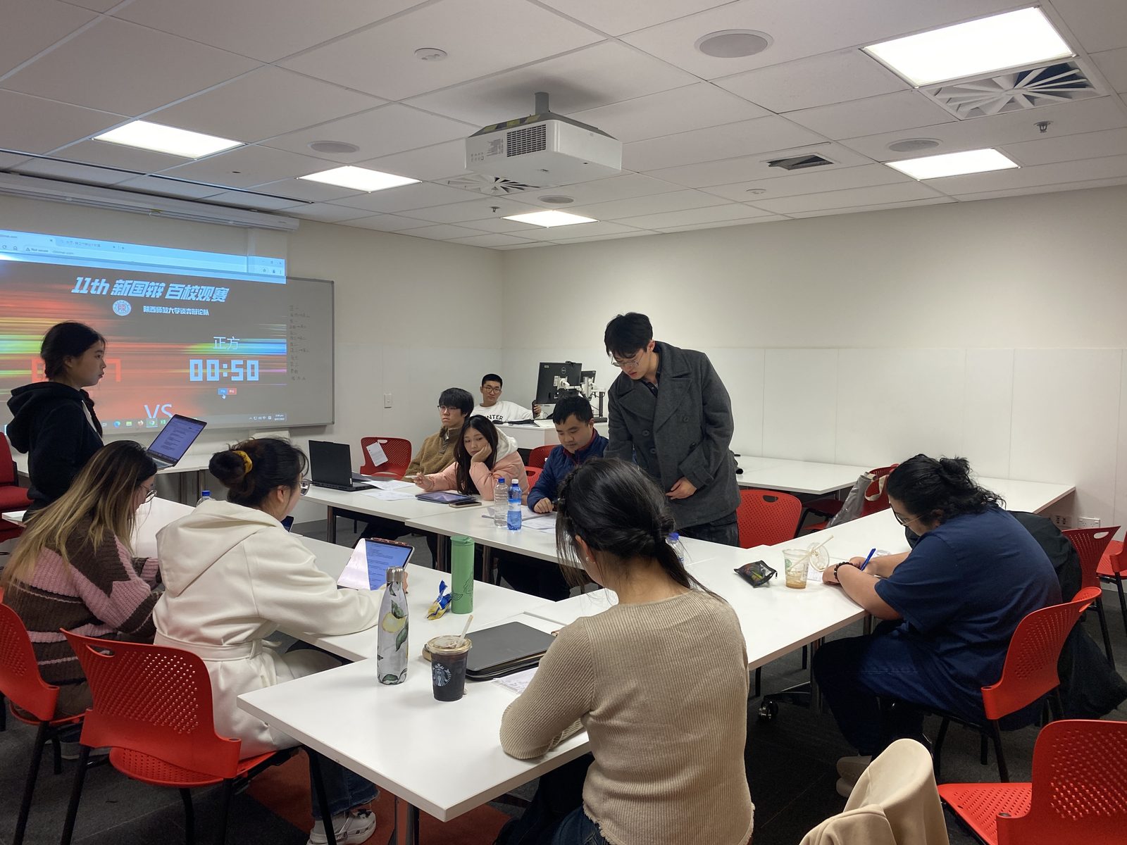 Members watching a debate together